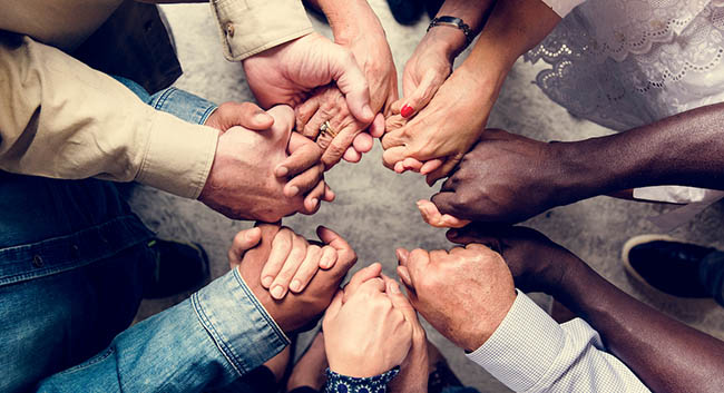 Group of diverse hands holding each other
